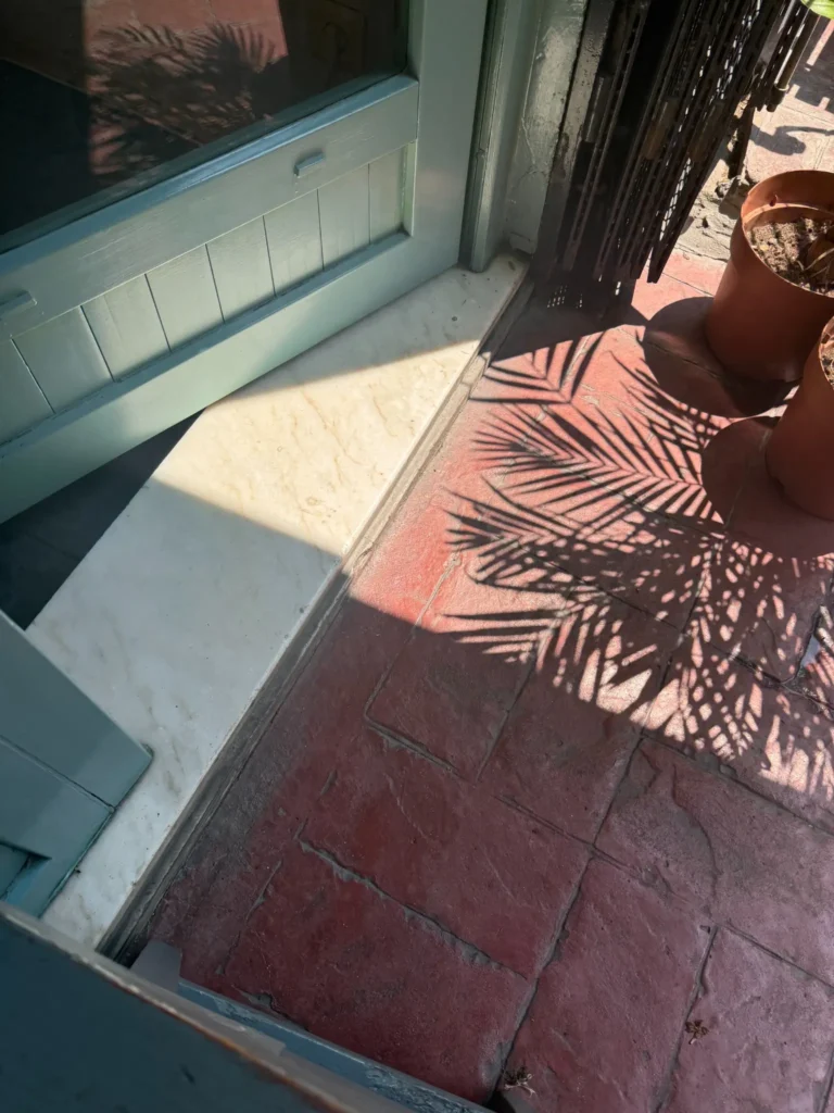 vegan restaurants in Istanbul – sunny street detail with palm shadows outside a small restaurant entrance, capturing the warm atmosphere of the city.