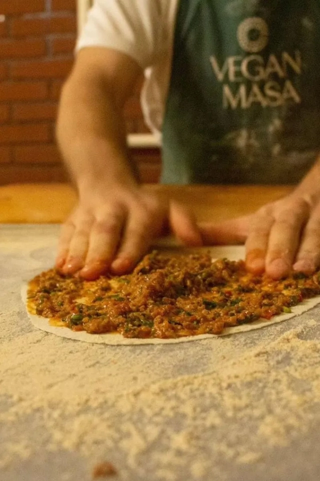 vegan restaurants in Istanbul, a close-up of a turkish pizza being prepared at vegan masa restaurant