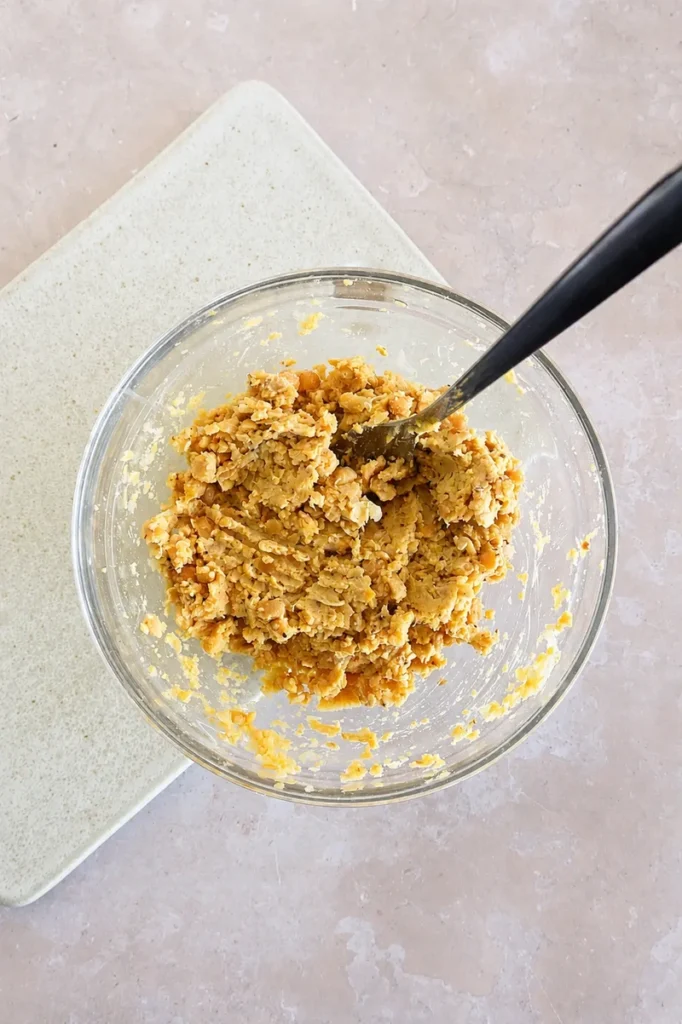 Vegan chickpea tuna salad fully mixed in a glass bowl with a chunky, creamy texture.
