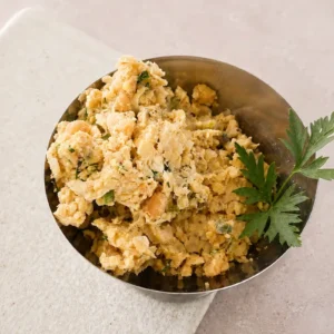 Vegan chickpea tuna salad served in a small metal bowl with fresh parsley garnish.