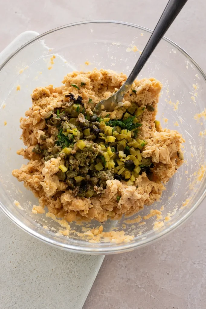 Vegan chickpea tuna salad with chopped pickles, capers, parsley, and nori added to the chickpea mixture.