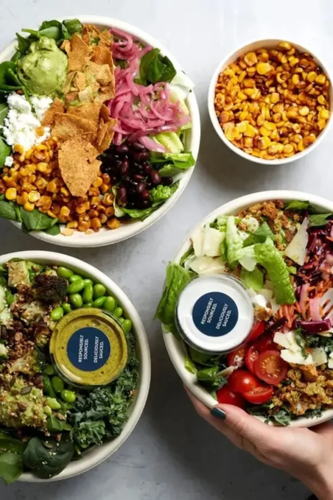 ATIS salad bowls top view with colourful vegetables, tofu, grains, greens, and plant-based toppings.