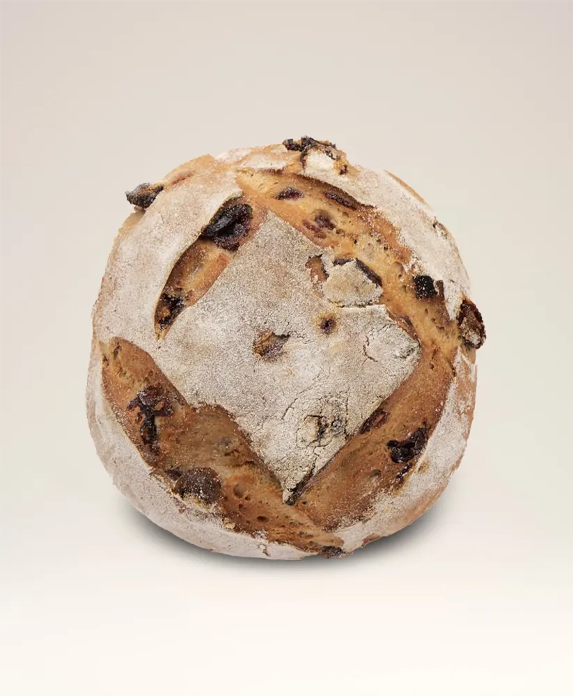Les Copains gluten-free bread loaf with golden crust, offered in a 100% gluten-free bakery in London.