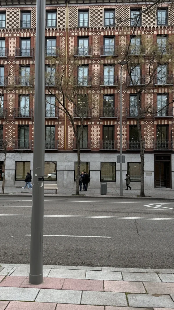 Vegan restaurants in Madrid, street photo of typical Madrid buildings with elegant balconies and historic facades, capturing the city atmosphere for a vegan food guide.