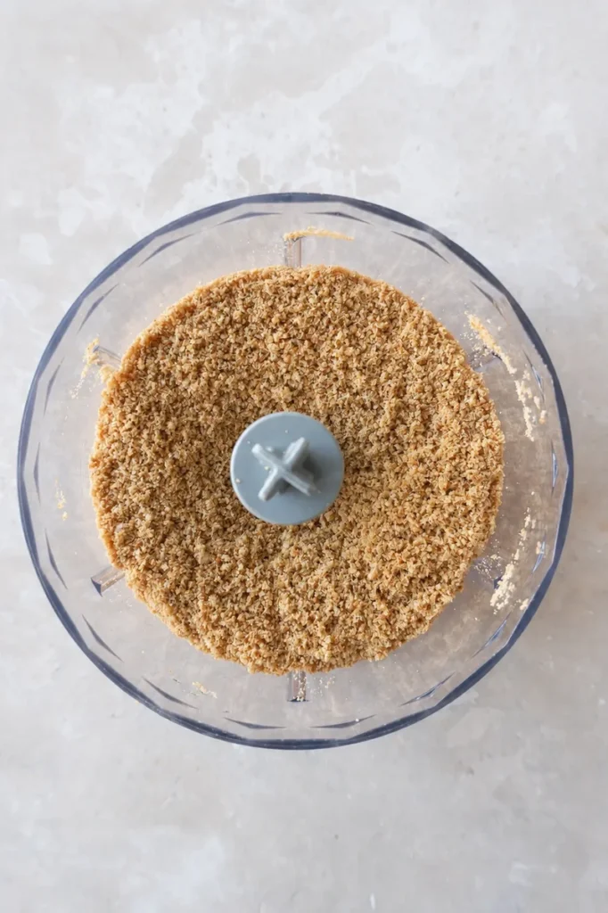 Vegan strawberry cheesecake cookie crumbs blended in a food processor for the crust.