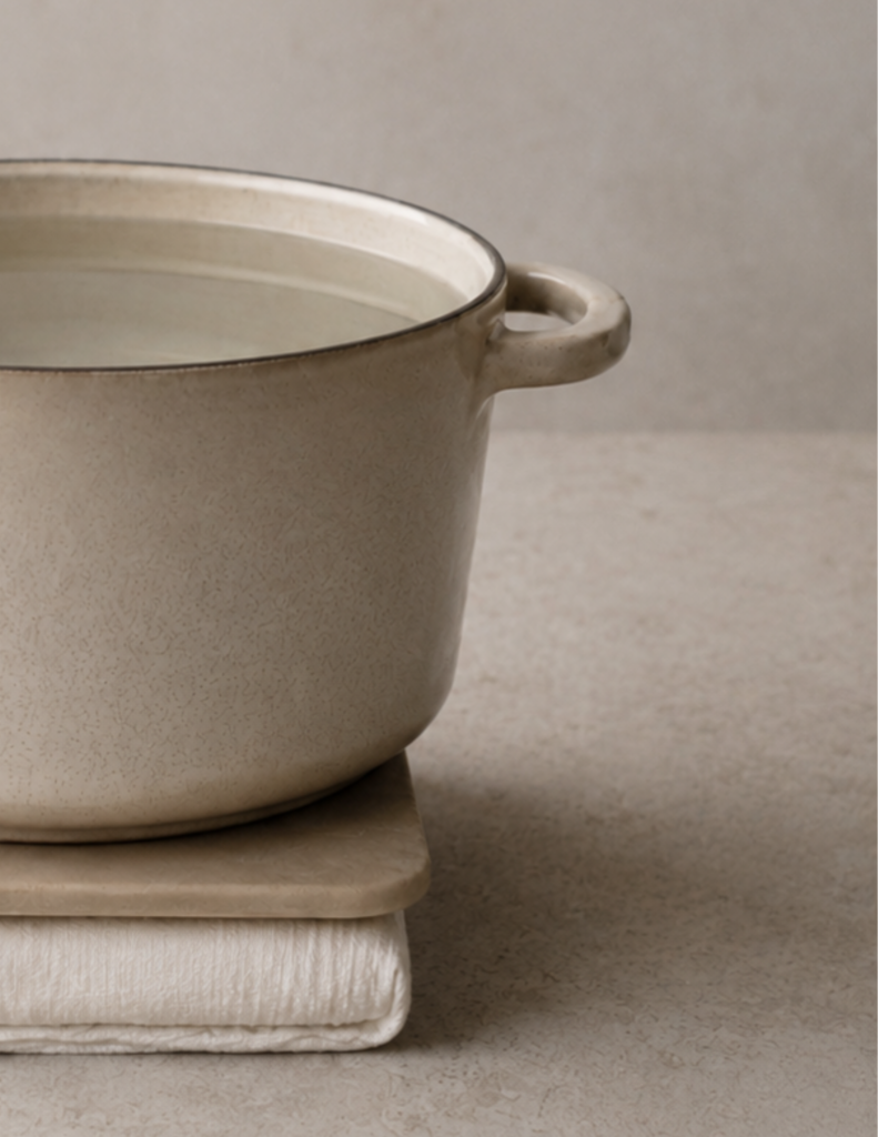 How to press tofu without a tofu press: a large water-filled pot placed over a board and towel-wrapped tofu to create a simple homemade tofu press.