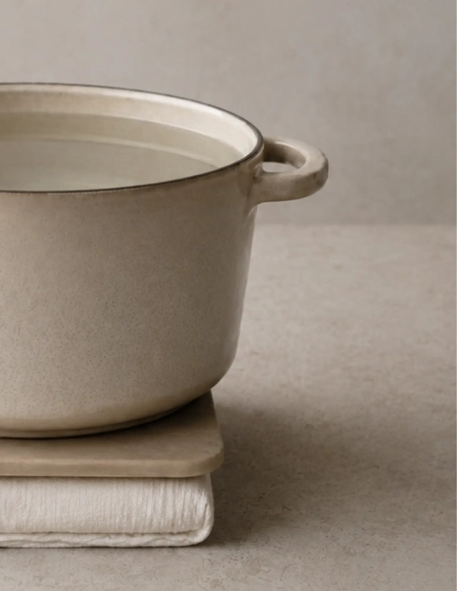 How to press tofu without a tofu press: a large water-filled pot placed over a board and towel-wrapped tofu to create a simple homemade tofu press.