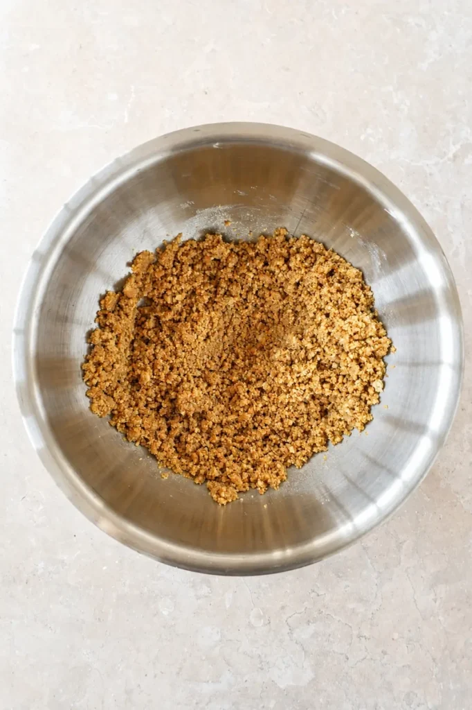 Vegan butter substitute being mixed with flour in a bowl to create a sandy pastry texture for plant-based baking.