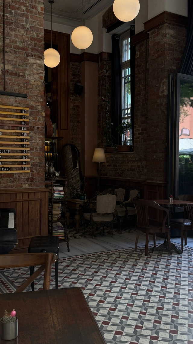 istanbul vegan restaurants guide, dark and stylish restaurant interior in Istanbul with warm lighting, modern design details, and an intimate evening atmosphere.