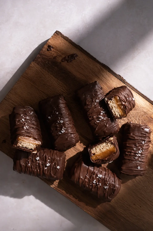 What I eat in a day as a vegan snack with homemade chocolate-covered bars, a soft caramel filling, and a sprinkle of sea salt.