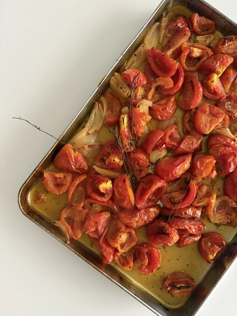 Roasted tomatoes, onion and garlic caramelized in the oven with herbs and olive oil, ready to be blended into an easy 3-ingredient tomato soup.