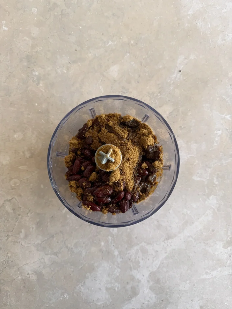 Red kidney beans, coconut sugar, maple syrup and vanilla in a food processor for high-protein vegan bean brownies.