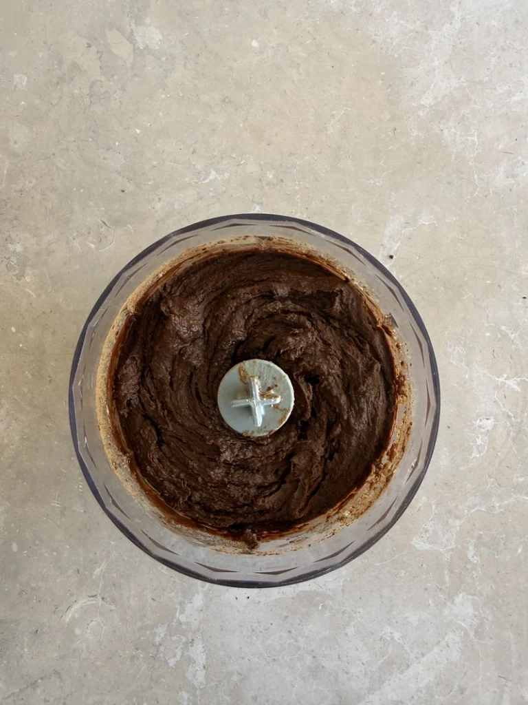 Chocolate and beans batter blended in a food processor for high-protein vegan bean brownies.
