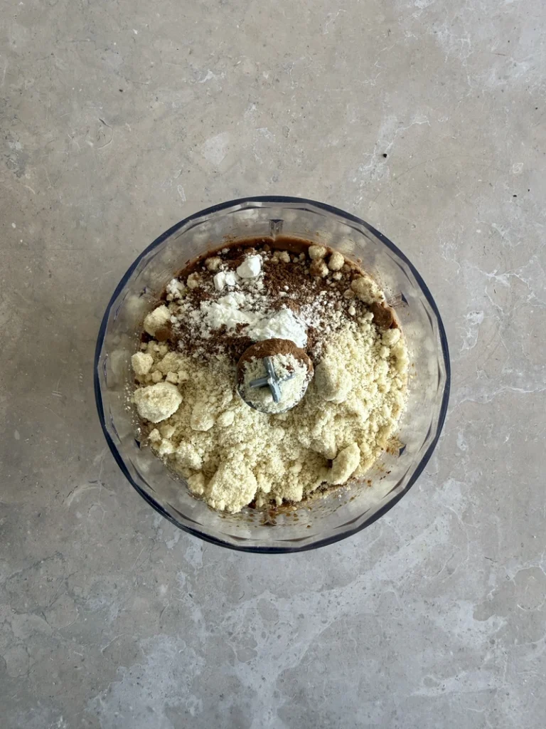 Almond flour, cocoa powder and baking powder added to the blended mixture for high-protein vegan bean brownies.