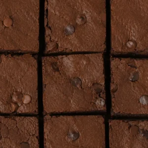 Close-up of high-protein vegan bean brownies cut into squares, with a fudgy chocolate texture and chocolate chips on top.