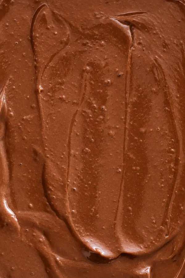 Creamy tofu chocolate pudding with a smooth, glossy texture and visible swirls of dark chocolate.