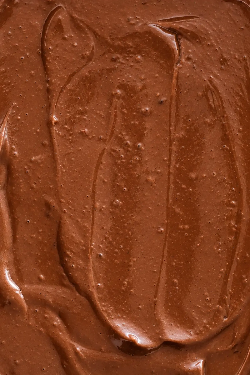 Creamy tofu chocolate pudding with a smooth, glossy texture and visible swirls of dark chocolate.