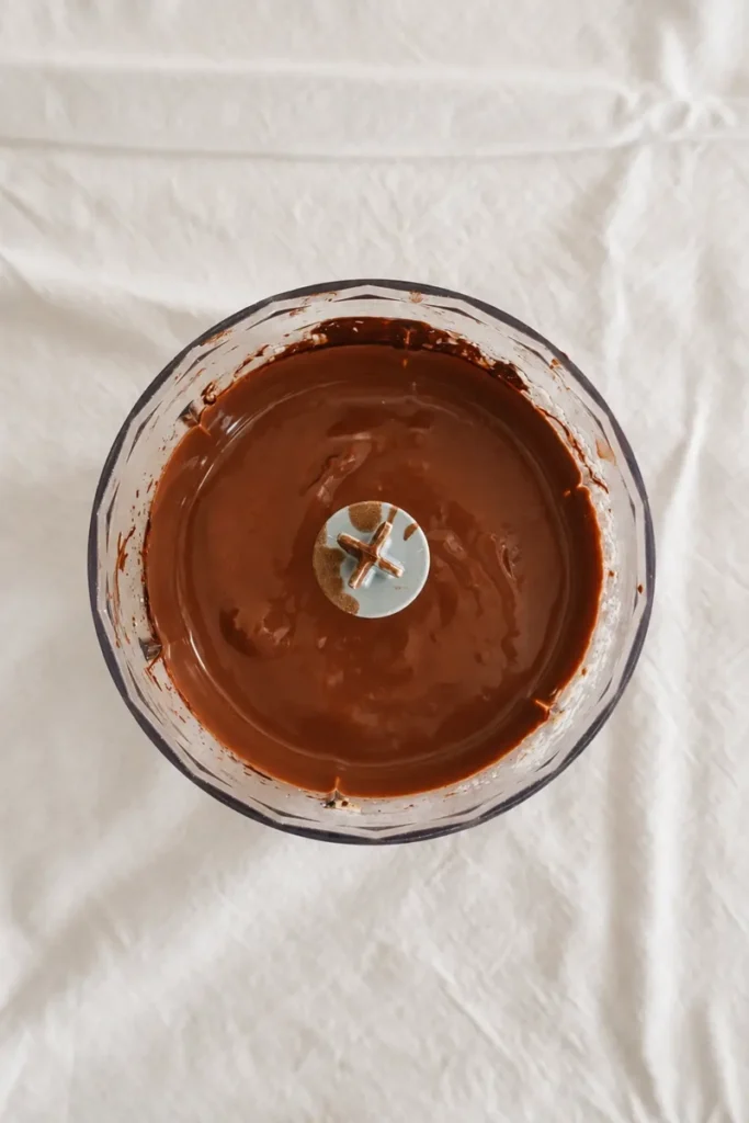 Smooth blended chocolate tofu mousse in a blender, ready to chill and set.
