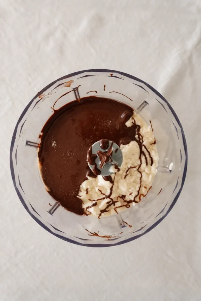 Silken tofu and melted dark chocolate in a blender before blending into chocolate tofu mousse.