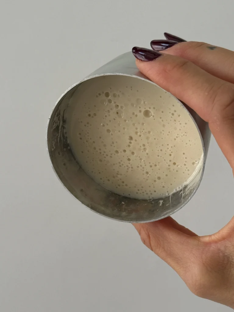 Set vegan panna cotta in a small metal mold, showing the firm and creamy texture after cooling.